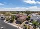 A beautiful home boasts a well-manicured lawn with mature trees and desert landscape at 18400 N Deer Grass Ct, Surprise, AZ 85374