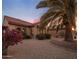 Charming single-story home featuring desert landscaping, gravel, and mature palm tree in the front yard at 18400 N Deer Grass Ct, Surprise, AZ 85374