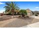 Home featuring mature landscaping, gravel, palm trees, and a two car garage at 18400 N Deer Grass Ct, Surprise, AZ 85374