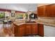 Open kitchen with granite countertops and stainless steel appliances, connected to a dining area at 18400 N Deer Grass Ct, Surprise, AZ 85374