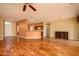 Open concept living room with hardwood floors connects to the kitchen through a breakfast bar at 18400 N Deer Grass Ct, Surprise, AZ 85374