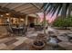 Charming outdoor space featuring a pergola, seating, and a lovely water feature at 18400 N Deer Grass Ct, Surprise, AZ 85374