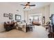 Serene main bedroom featuring a seating area, a ceiling fan, and plenty of natural light at 20006 W Highland Ave, Litchfield Park, AZ 85340