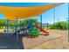 Modern playground equipment with sunshade, set against a background of parkland and hills at 20100 N 78Th Pl # 1104, Scottsdale, AZ 85255