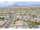 Wide aerial shot showcases neighborhood with homes featuring pools and outdoor amenities nestled against a mountain backdrop at 20618 W Western Dr, Buckeye, AZ 85396