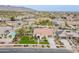Expansive aerial of a neighborhood showcasing a home with a putting green, and pool at 20618 W Western Dr, Buckeye, AZ 85396