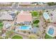 Stunning aerial view showcasing a home with a swimming pool, green grass, and manicured landscaping at 20618 W Western Dr, Buckeye, AZ 85396