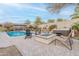 Backyard with a pool, hot tub, and fire pit creates a luxurious and inviting outdoor living space at 20618 W Western Dr, Buckeye, AZ 85396