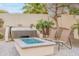 Backyard featuring a hot tub, fire pit, and lush landscaping for private outdoor enjoyment at 20618 W Western Dr, Buckeye, AZ 85396