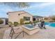 Backyard oasis with a fire pit, Adirondack chairs, and a pool for ultimate relaxation and entertainment at 20618 W Western Dr, Buckeye, AZ 85396
