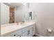 Bathroom featuring modern vanity with ample counter space, stylish fixtures, and a glass-enclosed shower at 20618 W Western Dr, Buckeye, AZ 85396