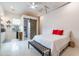 Well-lit bedroom showing barn door to bathroom, stylish bench, and neutral décor create a relaxing atmosphere at 20618 W Western Dr, Buckeye, AZ 85396