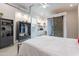 Bright bedroom featuring barn door to bathroom, modern furniture, and open closet for an efficient and stylish layout at 20618 W Western Dr, Buckeye, AZ 85396