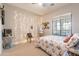 Bright bedroom featuring string lights, floral bedding, and a window, is perfect for relaxation and comfort at 20618 W Western Dr, Buckeye, AZ 85396