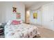 Cozy bedroom featuring floral bedding, soft decor, and access to a private bathroom offers a relaxing retreat at 20618 W Western Dr, Buckeye, AZ 85396