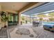 Enjoy outdoor dining on the covered patio with views of the landscaped backyard and pool at 20618 W Western Dr, Buckeye, AZ 85396