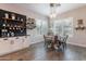 Eat-in kitchen with modern light fixture, lots of windows, tile floors, and stainless steel appliances at 20618 W Western Dr, Buckeye, AZ 85396