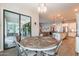 Bright dining area adjacent to the kitchen and with backyard access, modern light fixture, and tile floors at 20618 W Western Dr, Buckeye, AZ 85396