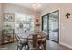 Cozy dining area with backyard access, modern light fixture, lots of windows, and tile floors at 20618 W Western Dr, Buckeye, AZ 85396