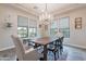 Elegant dining room features a chandelier, large table, and scenic views from the windows at 20618 W Western Dr, Buckeye, AZ 85396