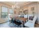 Bright dining room with a chandelier, a full bar, and large windows that provide lots of natural light at 20618 W Western Dr, Buckeye, AZ 85396