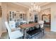 Bright dining room with a chandelier, a full bar, and large windows that provide lots of natural light at 20618 W Western Dr, Buckeye, AZ 85396