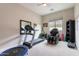 Bright exercise room featuring a treadmill, massage chair, and ample space for a home gym setup at 20618 W Western Dr, Buckeye, AZ 85396