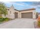 Spacious three car garage with neutral paint, tiled roof, and desert landscaping at 20618 W Western Dr, Buckeye, AZ 85396