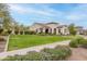 Beautifully landscaped home with lush greenery, a well-manicured lawn, and inviting curb appeal at 20618 W Western Dr, Buckeye, AZ 85396