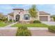 Charming home featuring a tile roof, arched entryway, manicured lawn, and an attached garage at 20618 W Western Dr, Buckeye, AZ 85396