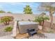 Relax and unwind in the backyard hot tub, surrounded by mature landscaping and privacy fencing at 20618 W Western Dr, Buckeye, AZ 85396