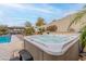 Backyard featuring a hot tub for relaxation and enjoyment, complemented by lush greenery at 20618 W Western Dr, Buckeye, AZ 85396