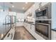 Kitchen featuring stainless steel appliances, white cabinets, dark countertops, tile floors and a breakfast bar at 20618 W Western Dr, Buckeye, AZ 85396