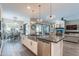 Stylish kitchen island with stainless steel sink, dishwasher, and seating, connecting to dining and living areas at 20618 W Western Dr, Buckeye, AZ 85396