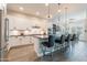 Open kitchen featuring a large island with seating, sleek white cabinets, and stainless steel appliances at 20618 W Western Dr, Buckeye, AZ 85396