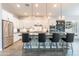 Modern kitchen with white cabinetry, stainless steel appliances, a patterned island, and pendant lighting at 20618 W Western Dr, Buckeye, AZ 85396