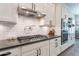 Kitchen with a gas range, stainless steel appliances, white cabinets and subway tile backsplash at 20618 W Western Dr, Buckeye, AZ 85396