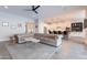 Open-concept living area featuring a plush sofa and view of the modern kitchen at 20618 W Western Dr, Buckeye, AZ 85396