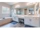 Luxurious main bathroom with double vanities, soaking tub, and a separate glass shower at 20618 W Western Dr, Buckeye, AZ 85396