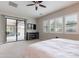 Comfortable main bedroom with sliding glass doors, a ceiling fan, and an entertainment center at 20618 W Western Dr, Buckeye, AZ 85396