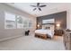Serene main bedroom with a dark accent wall, plantation shutters, and neutral color palette at 20618 W Western Dr, Buckeye, AZ 85396
