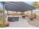 Covered outdoor kitchen features built-in grill, bar seating, and paver patio at 20618 W Western Dr, Buckeye, AZ 85396