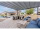 Outdoor living space with built-in grill, dining and lounge areas overlooking pool and putting green at 20618 W Western Dr, Buckeye, AZ 85396