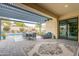 Inviting covered patio with stylish furniture, dining area, and seamless indoor-outdoor flow at 20618 W Western Dr, Buckeye, AZ 85396