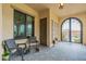 Charming front patio featuring comfortable seating and decorative tile flooring, creating a welcoming entrance at 20618 W Western Dr, Buckeye, AZ 85396