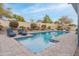 Sparkling pool with patio lounge area featuring mature landscaping and privacy walls at 20618 W Western Dr, Buckeye, AZ 85396