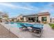 Backyard features a sparkling pool, lounge chairs, and covered patio, perfect for outdoor living at 20618 W Western Dr, Buckeye, AZ 85396