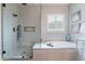 Detailed view of the main bathroom's shower and soaking tub, with light tile and fixtures at 20618 W Western Dr, Buckeye, AZ 85396