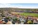 Aerial view of a neighborhood, golf course and distant mountains at 22416 N Arrellaga Dr, Sun City West, AZ 85375