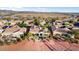Scenic aerial view of a desert community featuring single-story homes, mature landscaping, and views of mountains in the distance at 22416 N Arrellaga Dr, Sun City West, AZ 85375